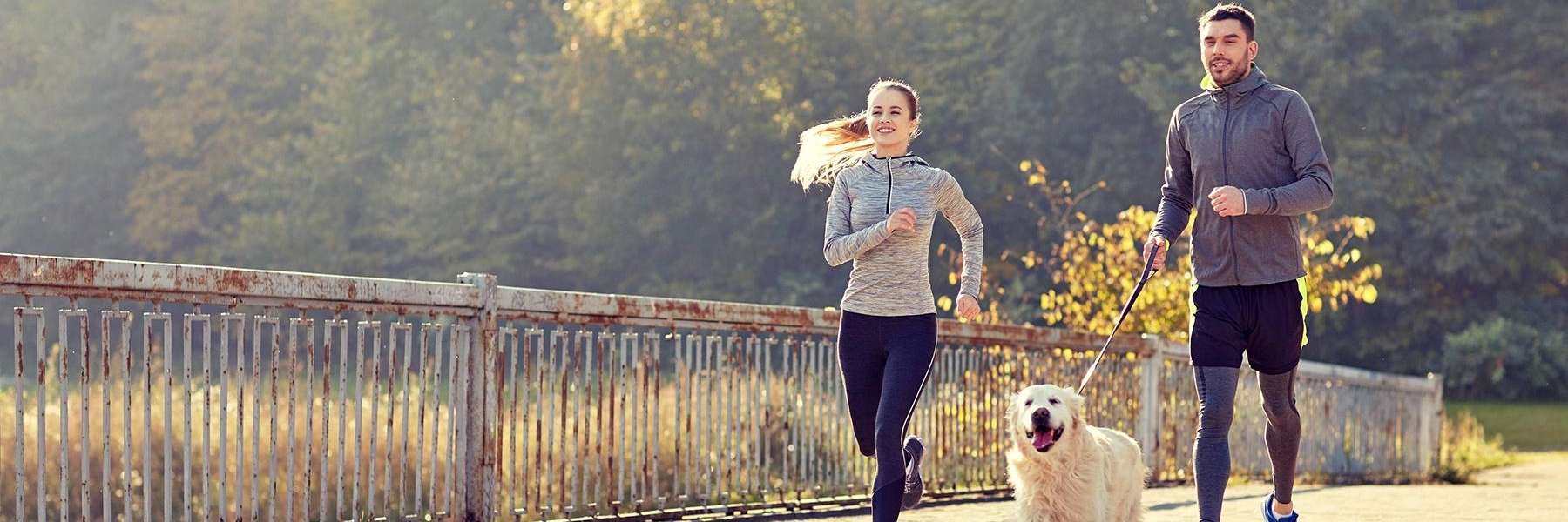 couple jogging with their dog